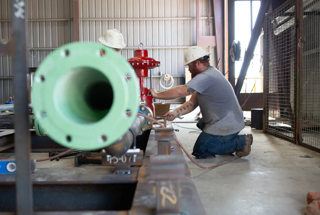 A man working on product pipes.